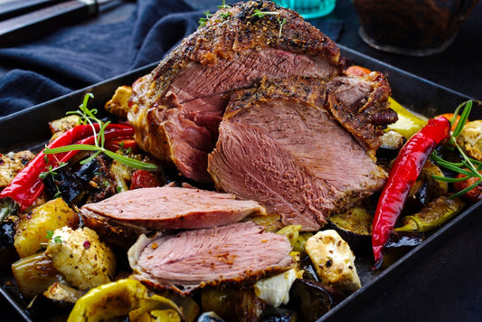 Roasted lamb with vegetables on a black plate