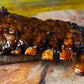 Braised ribs with a glossy sauce on a wooden cutting board